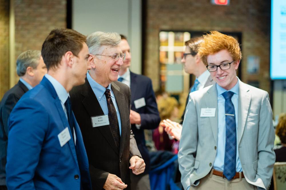 Student chatting with two donors at Scholarship Dinner 2019